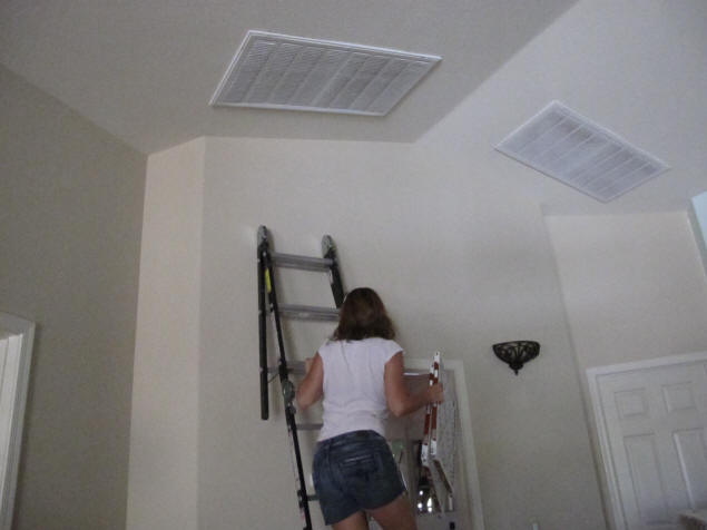 Jenny prepares to change the HVAC filters.