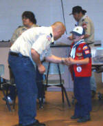 Zach receives his badge and new rank from new Packmaster Ryan.