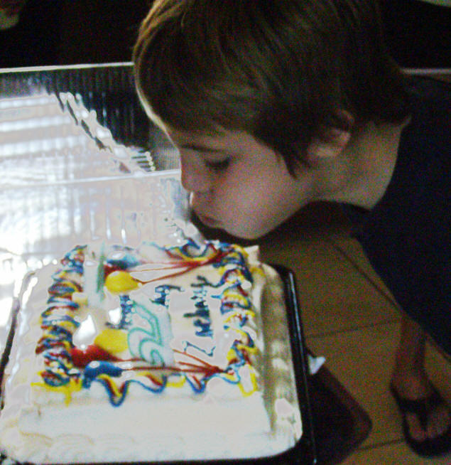 Zach blows out his candles.