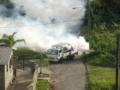Mosquito-control truck fogging DDT.