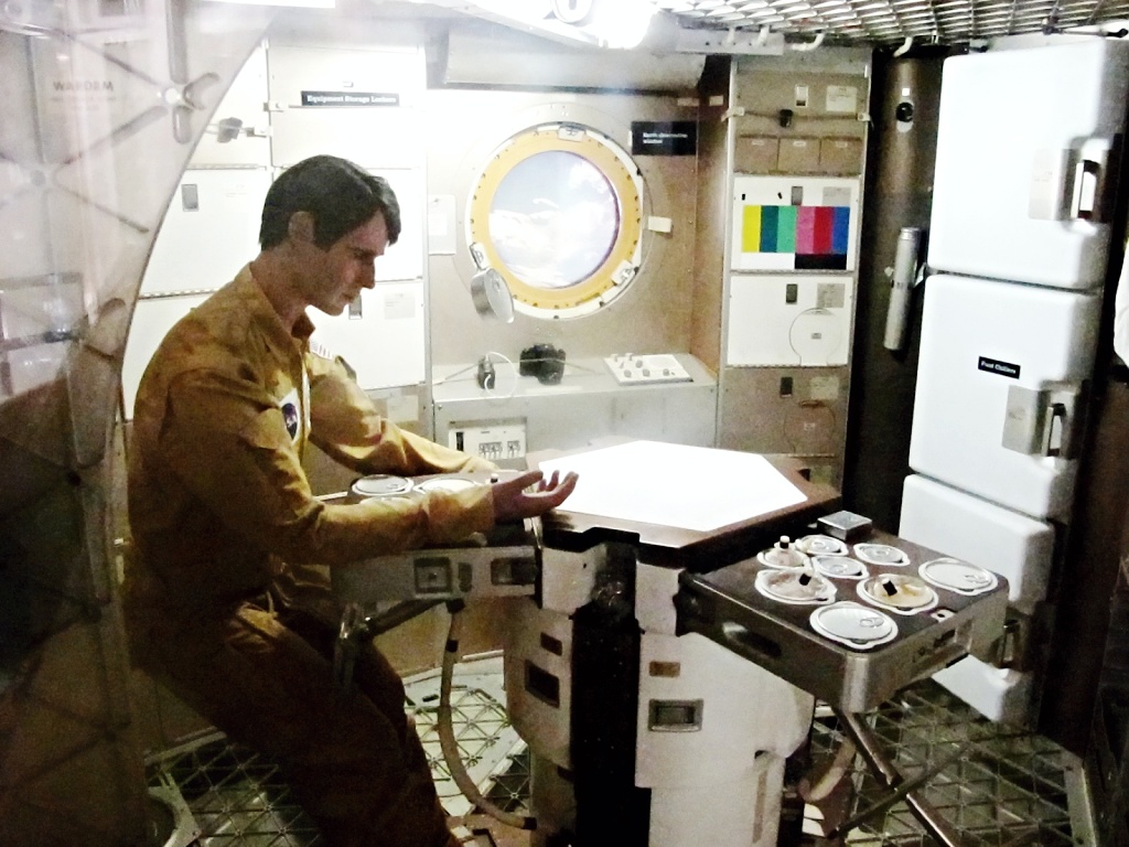 A mockup astronaut has breakfast in Skylab.