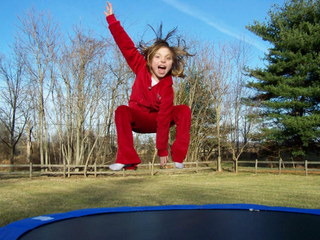 Cailey above her new trampoline.