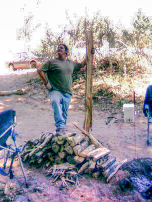 Eddie's Captain Morgan moment atop the firewood he gallantly chopped.