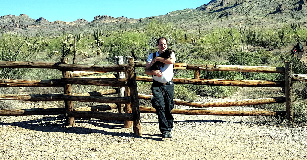 Alex carrying Blackie from Treasure Loop Trail, Lost Dutchman State Park