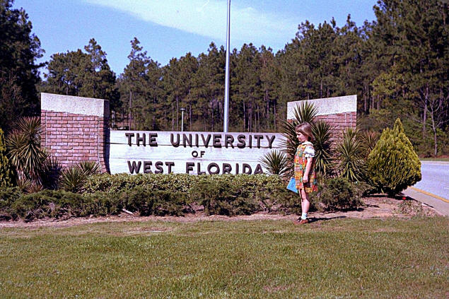 The University of West Florida; Dottie in front of the sign.