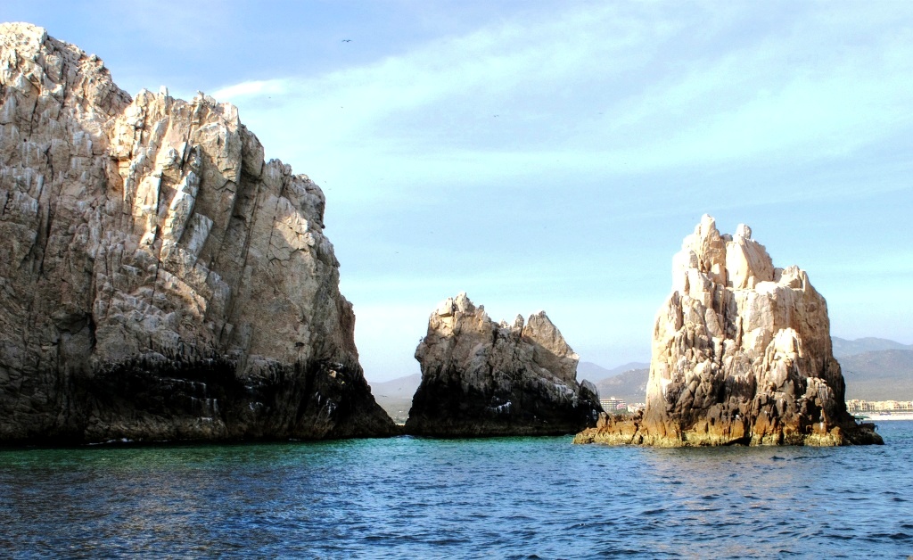 Cabo is seen beyond the rocky islands.